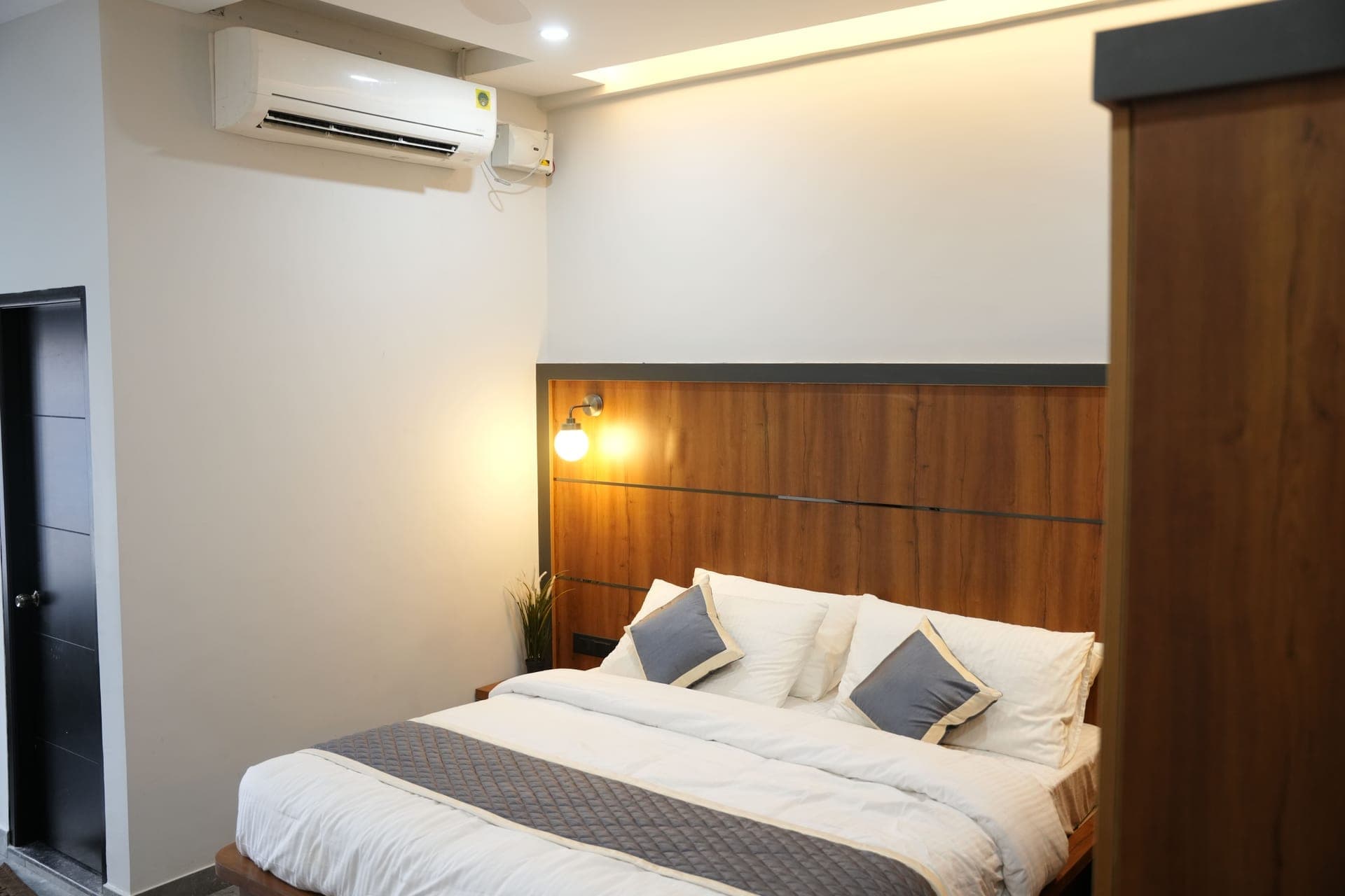 Deluxe room interior at Sarvam Residency Sagara — air-conditioned with modern furnishings